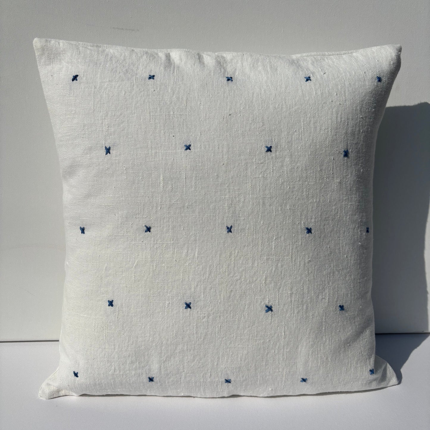 Handmade white linen cushion blue embroidery