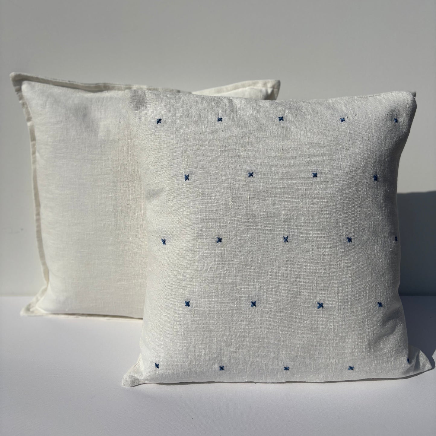 Handmade white linen cushion blue embroidery